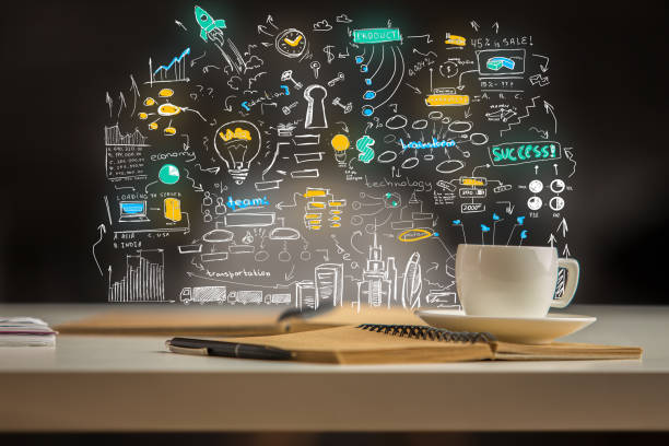 Close up of creative workplace with abstract business sketch, coffee cup, notepad and other items