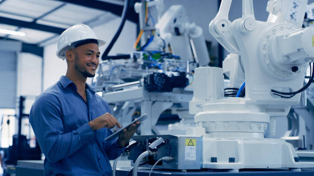 Engineer, man smile and tablet research with robotics, machine learning and futuristic digital data. Engineering, employee and robot function check of male worker doing an analysis on automation
