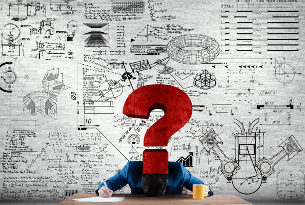 Businessman with his head on the desk looking to solve some math problems